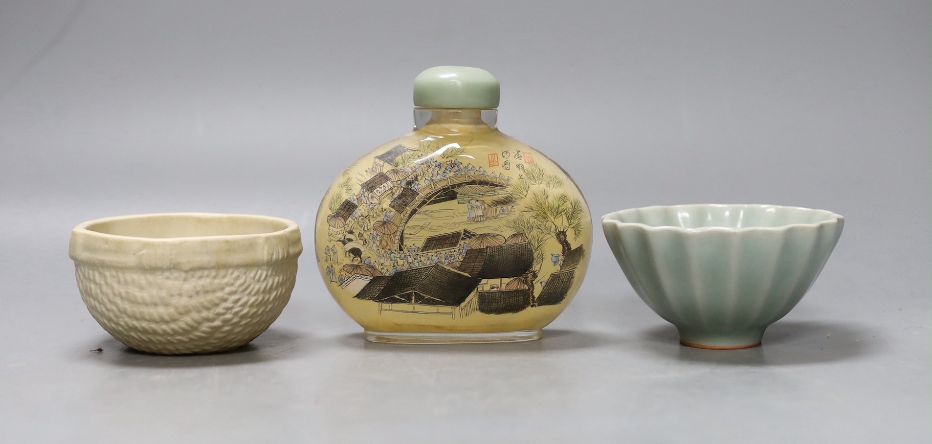 A Chinese inside-painted glass snuff bottle and cover, 10cm high, a Chinese Ming type basketware cup and a Chinese celadon fluted cup